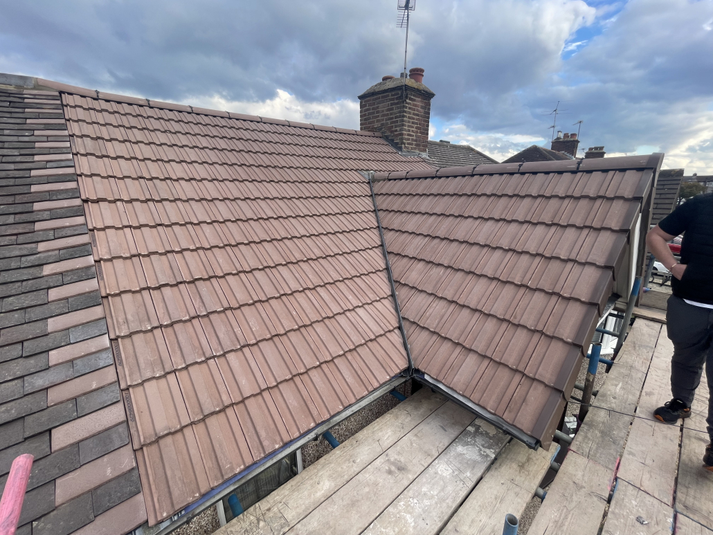 Close-up of a slate rooftop featuring dormer windows under daylight in Leicestershire